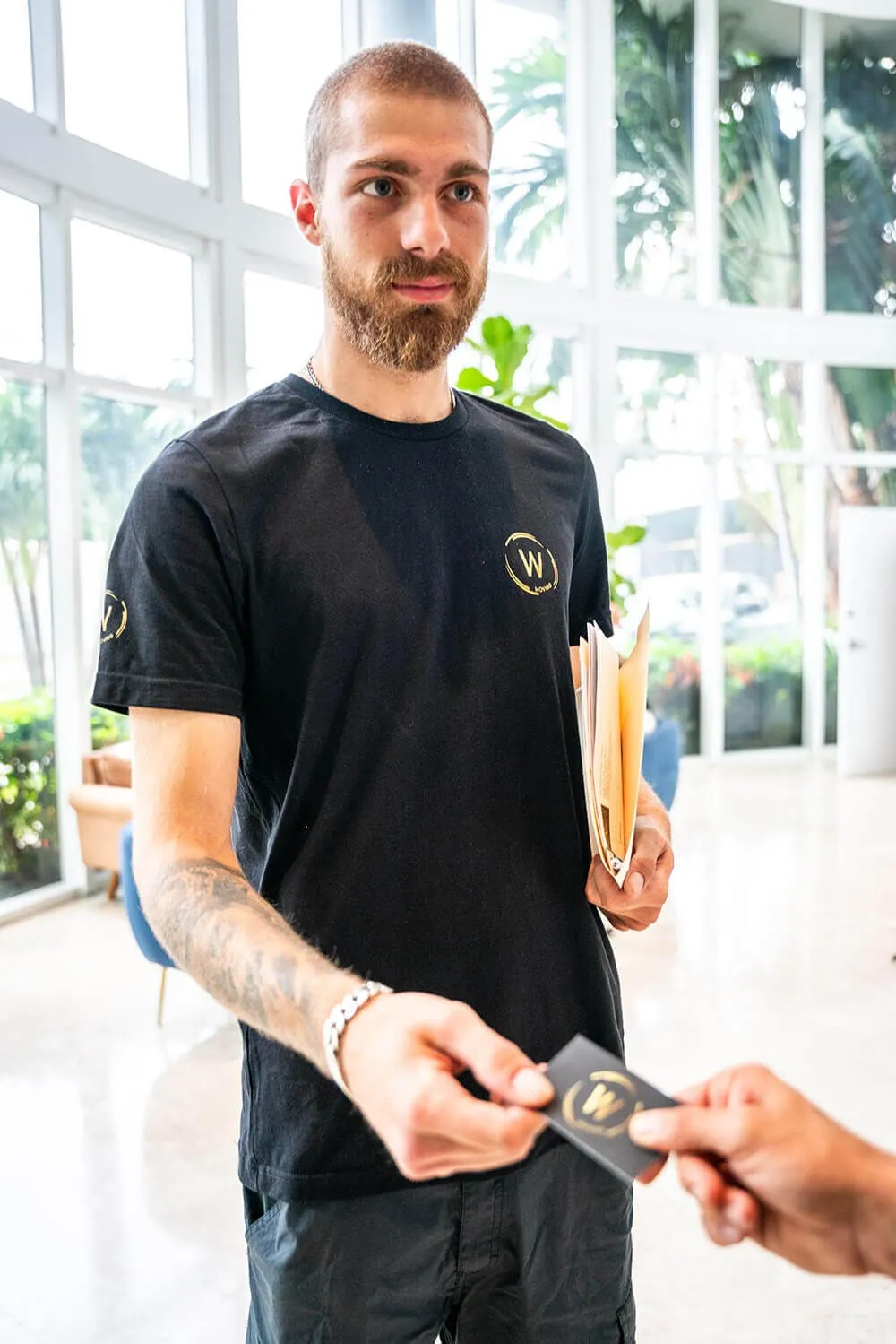 W Moving and Storage Team Member Giving Business Card
